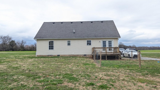 back of house with crawl space, a lawn, a wooden deck, and a shingled roof