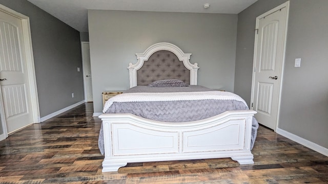 bedroom featuring dark wood-style floors and baseboards