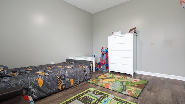 bedroom featuring baseboards and wood finished floors