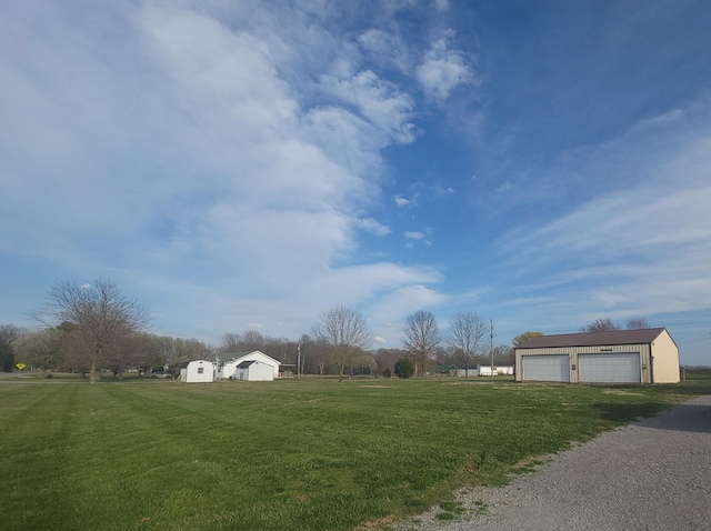 view of yard featuring a garage and an outdoor structure