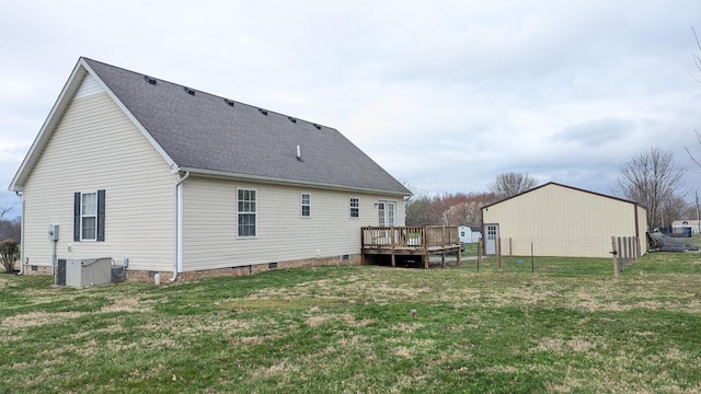 rear view of house with a wooden deck, central AC, a shingled roof, crawl space, and a lawn