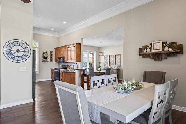 dining room with ornamental molding, dark wood-style floors, baseboards, and recessed lighting