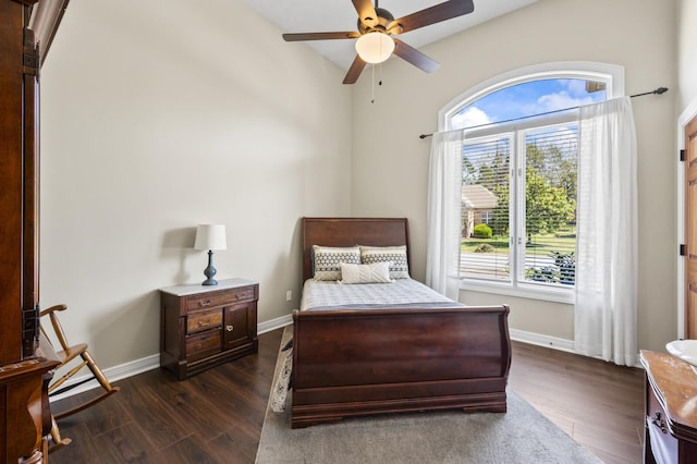 bedroom with baseboards, ceiling fan, and dark wood-type flooring