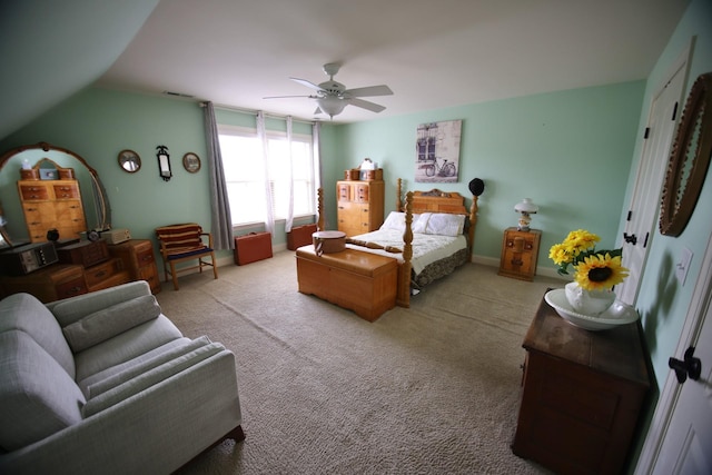 carpeted bedroom with vaulted ceiling, baseboards, and ceiling fan