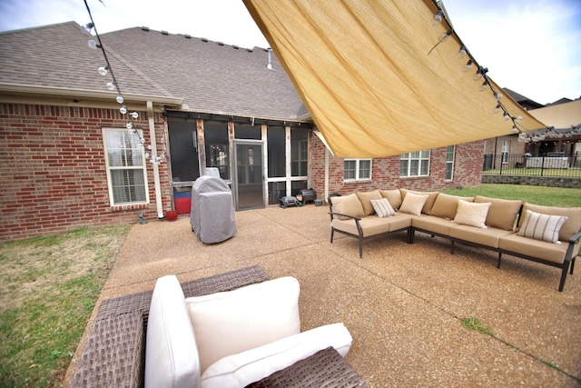 view of patio / terrace featuring a grill, fence, a sunroom, and an outdoor hangout area