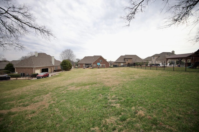 view of yard featuring a residential view and fence