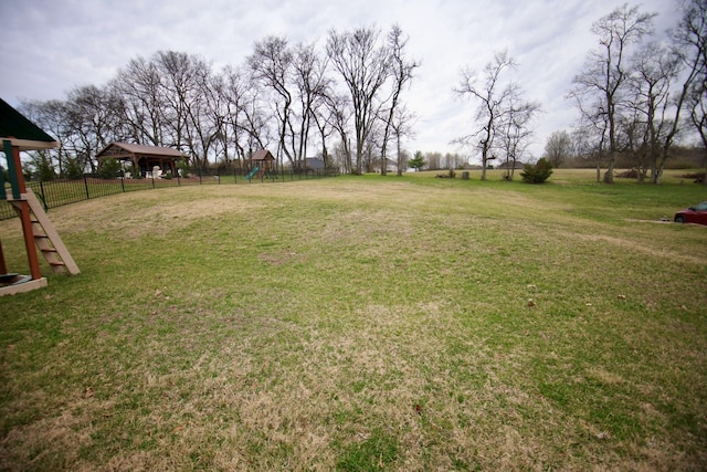 view of yard with playground community and fence