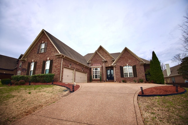traditional-style home featuring brick siding, concrete driveway, and an attached garage
