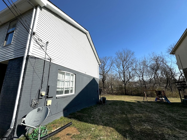 1239 N Graycroft Ave, Madison, TN 37115 - view of side of home featuring a playground, a lawn, brick siding, and crawl space