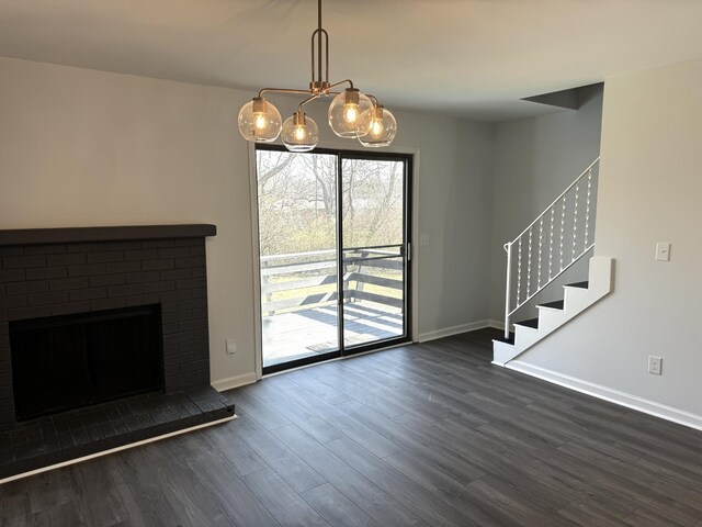 1239 N Graycroft Ave, Madison, TN 37115 - unfurnished living room with dark wood finished floors, stairs, a fireplace, and baseboards
