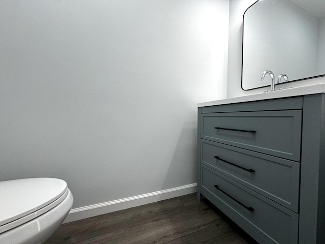 1239 N Graycroft Ave, Madison, TN 37115 - half bathroom featuring toilet, vanity, baseboards, and wood finished floors