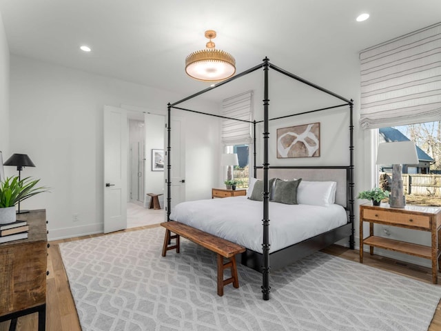 bedroom featuring recessed lighting, baseboards, and light wood-style floors
