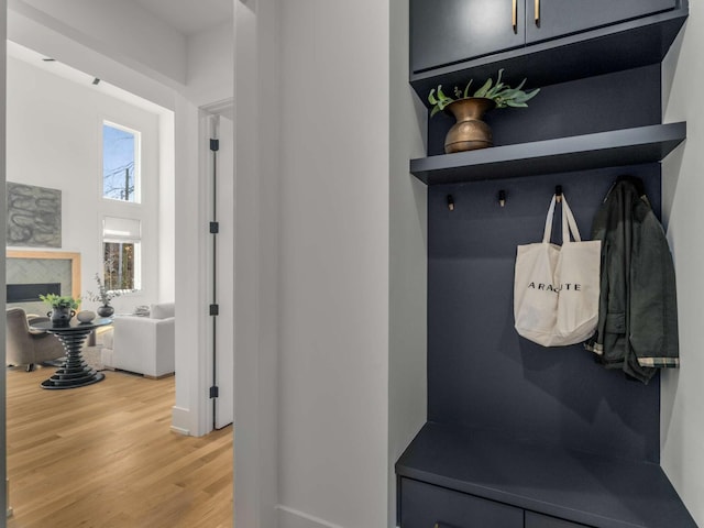 mudroom with baseboards and light wood finished floors