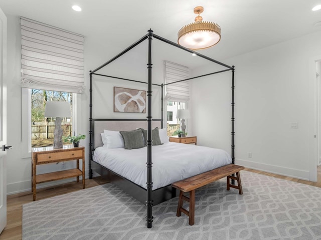 bedroom with recessed lighting, baseboards, and wood finished floors