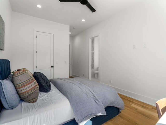 bedroom featuring recessed lighting, baseboards, a ceiling fan, wood finished floors, and ensuite bathroom