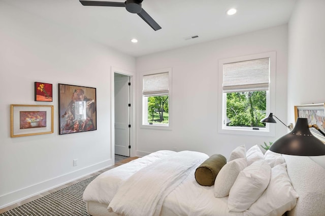 bedroom with visible vents, wood finished floors, baseboards, ceiling fan, and recessed lighting