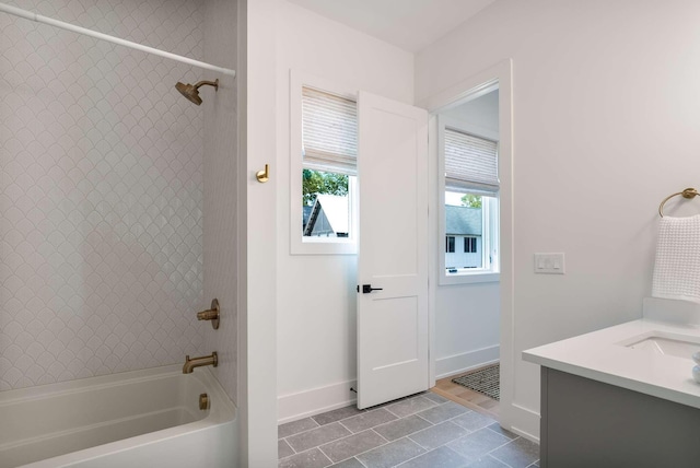 bathroom with shower / bath combination, tile patterned floors, baseboards, and vanity