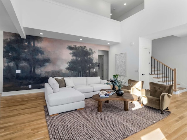 living room featuring baseboards, recessed lighting, wood finished floors, and stairway