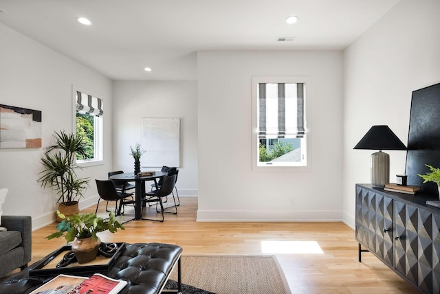 living area with recessed lighting, baseboards, visible vents, and light wood-style flooring
