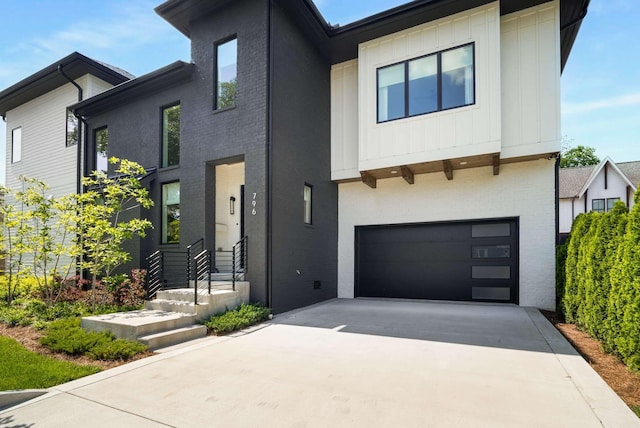 modern home with concrete driveway, brick siding, and an attached garage