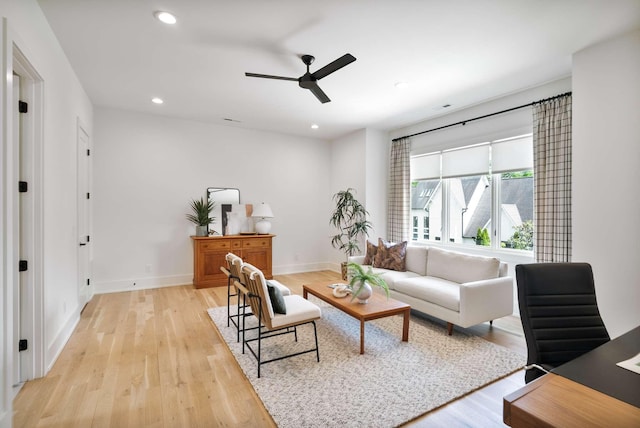 living room featuring baseboards, recessed lighting, light wood-style flooring, and ceiling fan