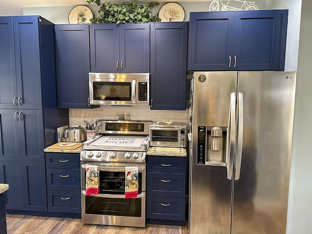 670 Jones Franklin Rd, Morristown, TN 37813 - kitchen with stainless steel appliances, blue cabinetry, and wood finished floors