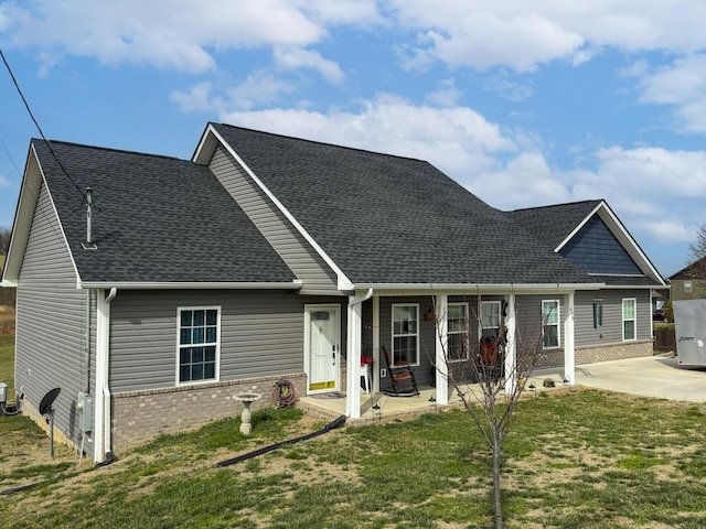 670 Jones Franklin Rd, Morristown, TN 37813 - view of front of property with roof with shingles, brick siding, a front lawn, and a patio