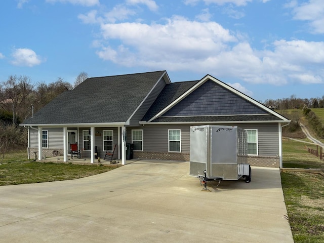 670 Jones Franklin Rd, Morristown, TN 37813 - rear view of property featuring covered porch, brick siding, a shingled roof, and a yard