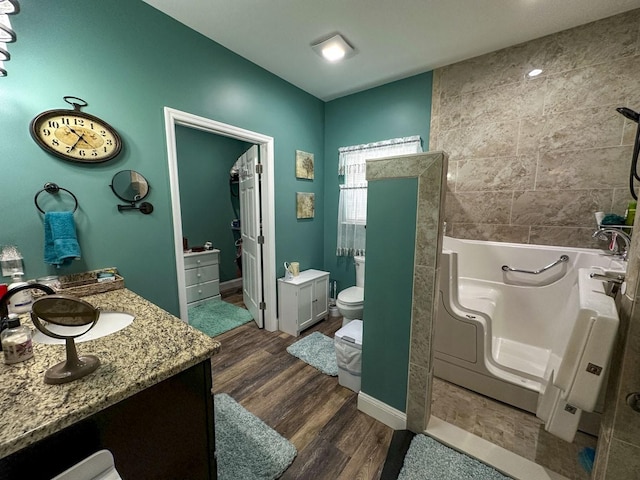 670 Jones Franklin Rd, Morristown, TN 37813 - full bath with toilet, a bath, vanity, wood finished floors, and baseboards