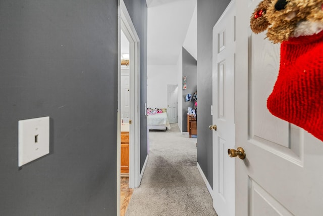 hall with baseboards and carpet