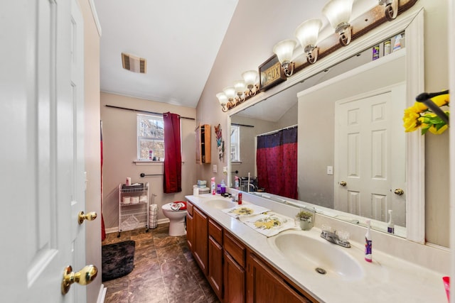 bathroom with a sink, visible vents, lofted ceiling, and toilet