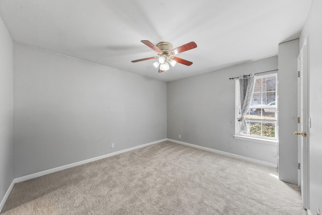 carpeted empty room with baseboards and ceiling fan