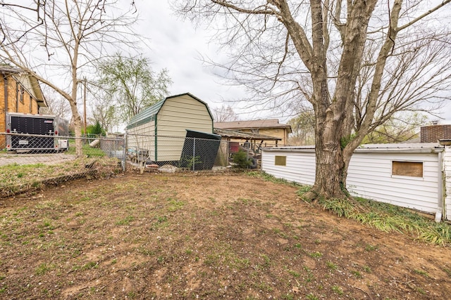 view of yard with an outbuilding and fence