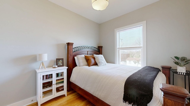 bedroom featuring baseboards and light wood-style flooring