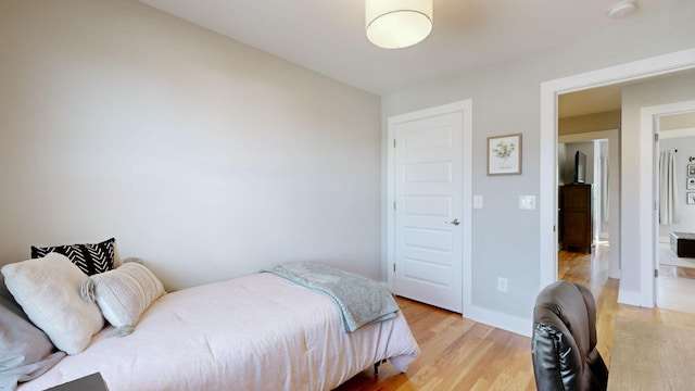bedroom featuring light wood-type flooring and baseboards