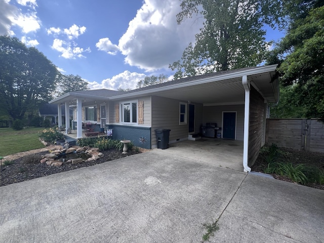 216 1st St, Monteagle, TN 37356 - view of front facade featuring concrete driveway, fence, covered porch, and a carport