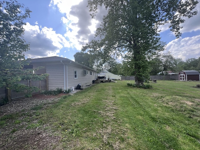 216 1st St, Monteagle, TN 37356 - view of yard featuring fence, a storage unit, and an outbuilding