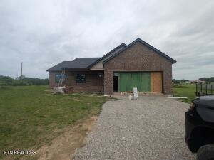 238 Thacker Rd, Grimsley, TN 38565 - view of front of house with driveway, a garage, and a front yard