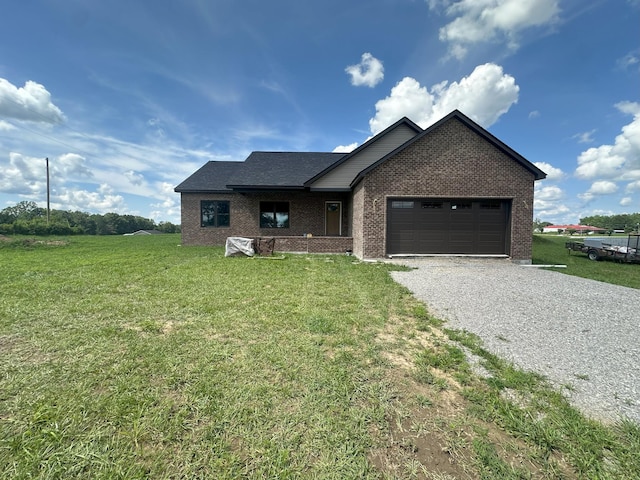 238 Thacker Rd, Grimsley, TN 38565 - view of front facade with gravel driveway, brick siding, a front lawn, and a garage
