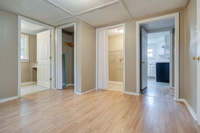 300 E Highland Dr, Columbia, TN 38401 - unfurnished bedroom with ensuite bath, a spacious closet, light wood-style floors, and baseboards