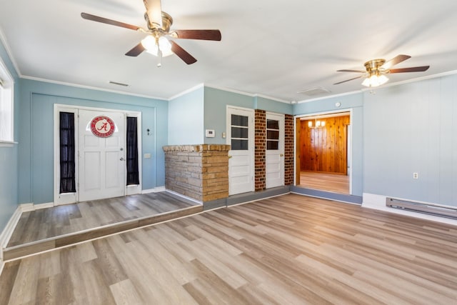 entryway with visible vents, wood finished floors, crown molding, baseboards, and ceiling fan