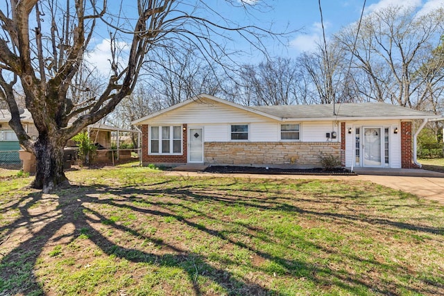 ranch-style home featuring brick siding, stone siding, a front lawn, and fence