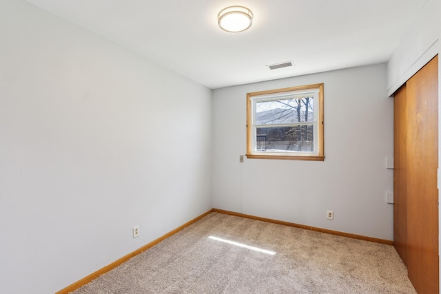 unfurnished bedroom with visible vents, baseboards, and carpet
