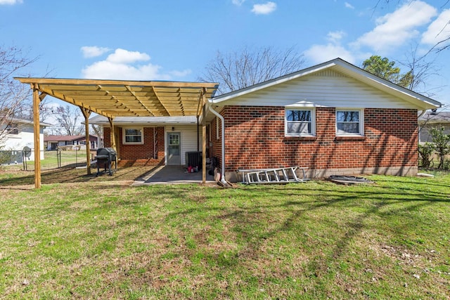 rear view of property featuring a lawn, a pergola, a patio, and fence