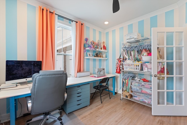 office with light wood-style floors, a ceiling fan, and wallpapered walls