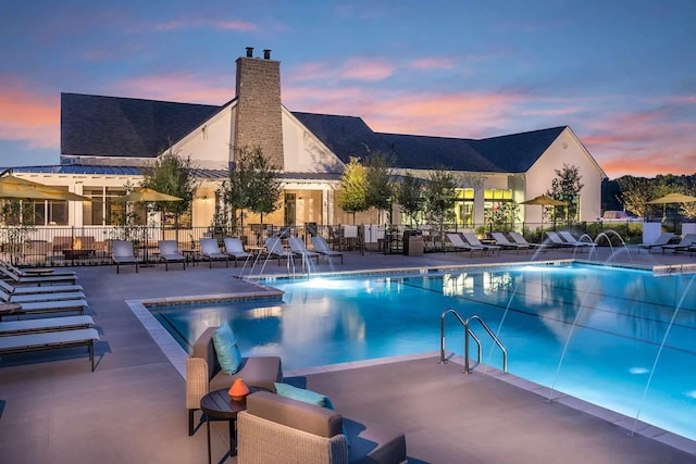 community pool featuring a patio and fence