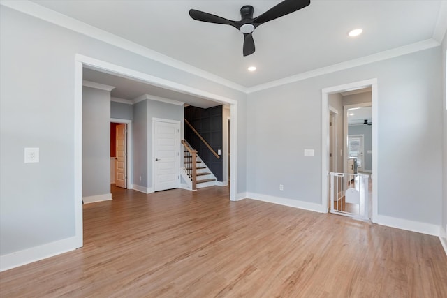 spare room featuring baseboards, light wood-type flooring, and a ceiling fan