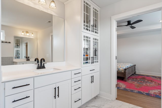 bathroom featuring visible vents, marble finish floor, a ceiling fan, baseboards, and vanity