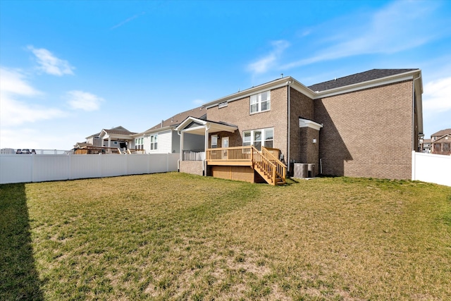 rear view of house with stairway, central AC unit, a fenced backyard, a deck, and a lawn