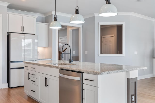 kitchen featuring dishwasher, light wood-type flooring, freestanding refrigerator, and a sink